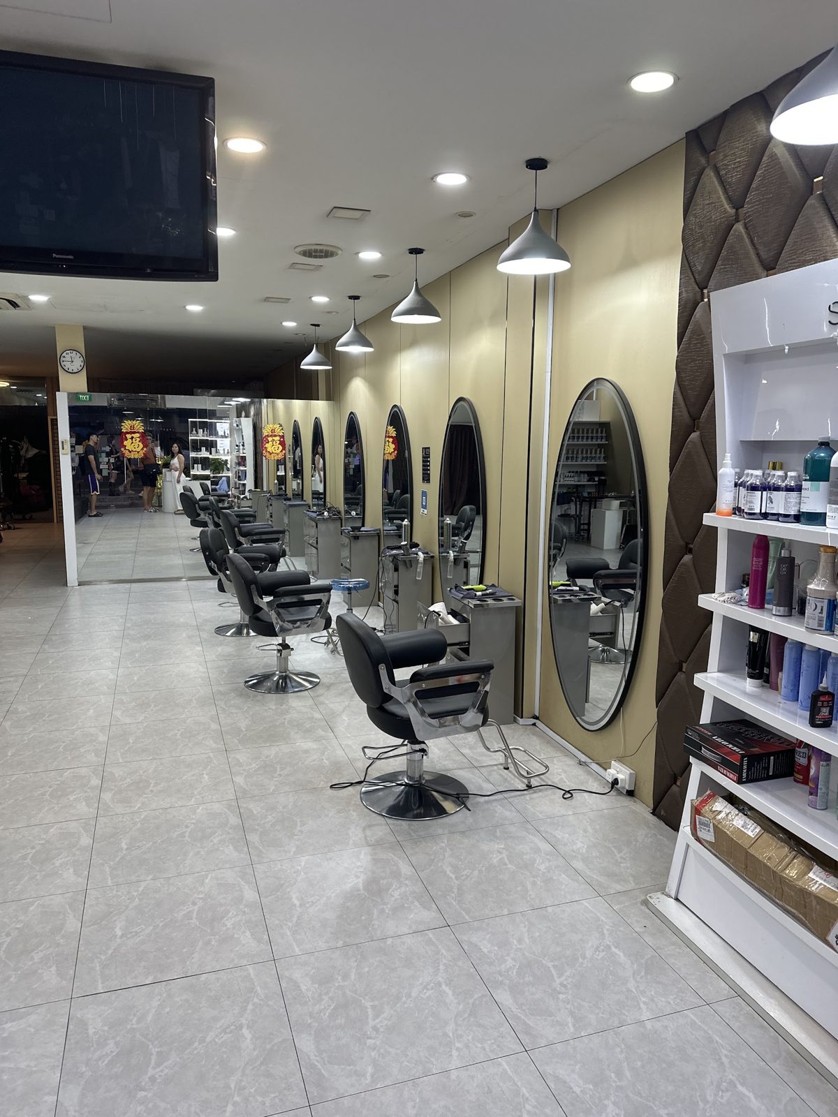 The salon floor, chairs and mirrors under warm lighting