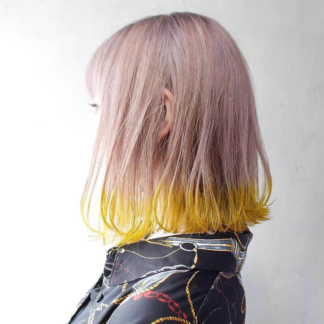 A pink to yellow ombre bob